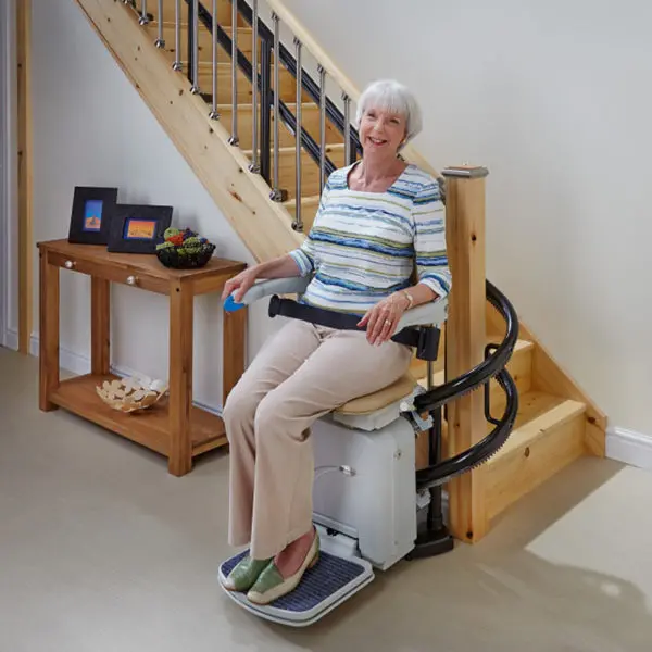 Lady in curved stair lift