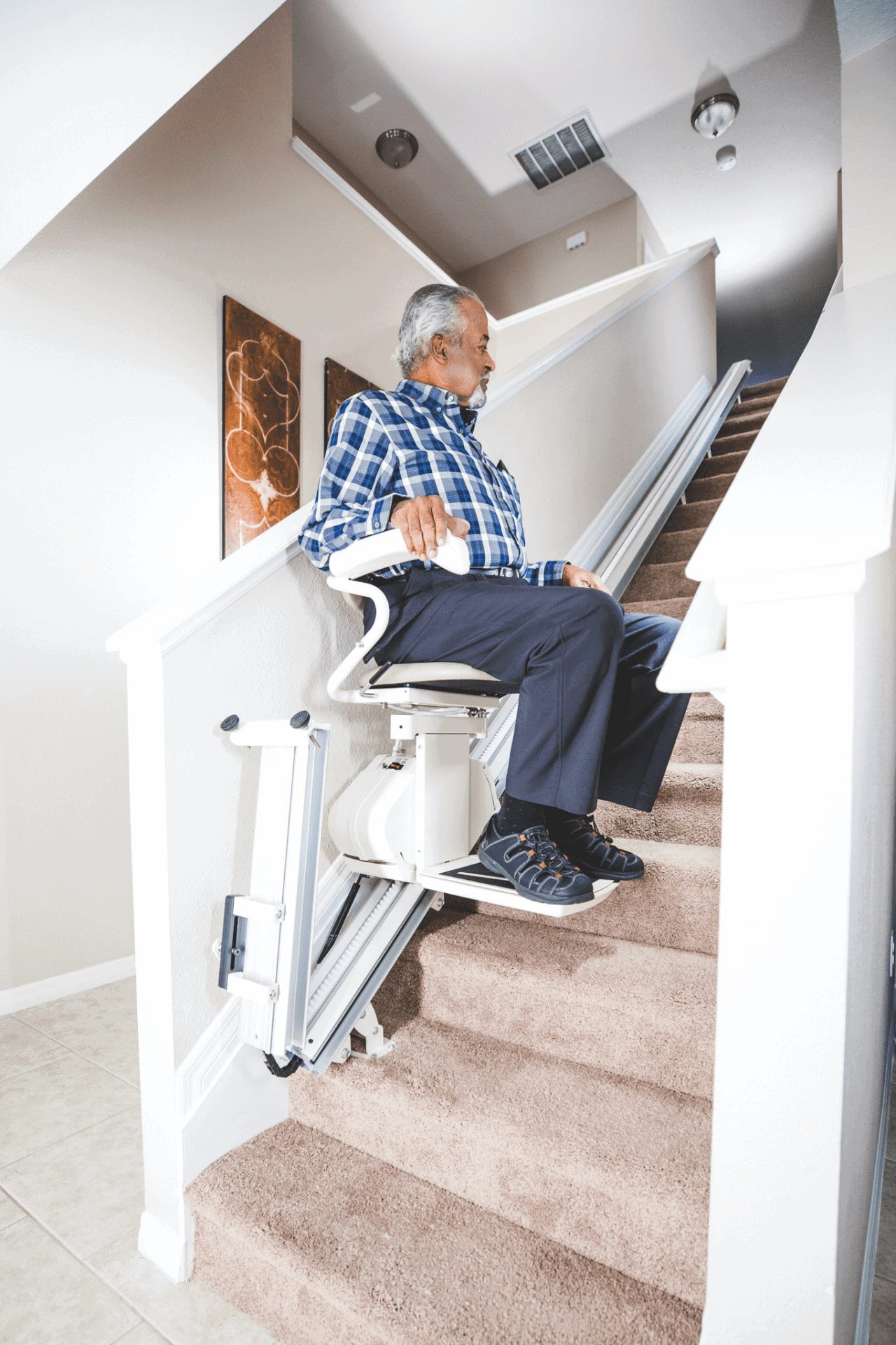 Man riding stairlift with automatic rail flip