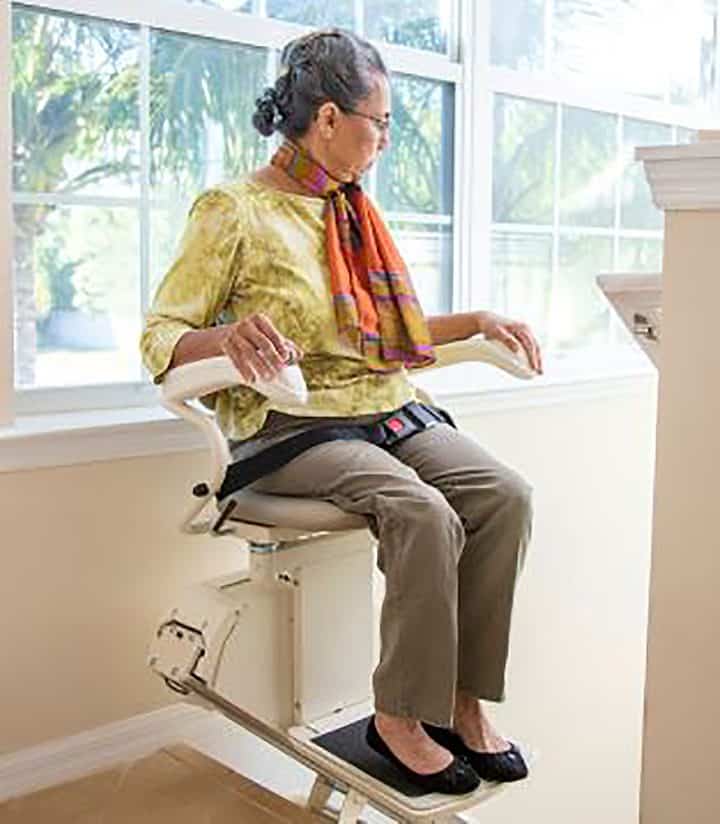 Woman riding Harmar SL300 stair lift